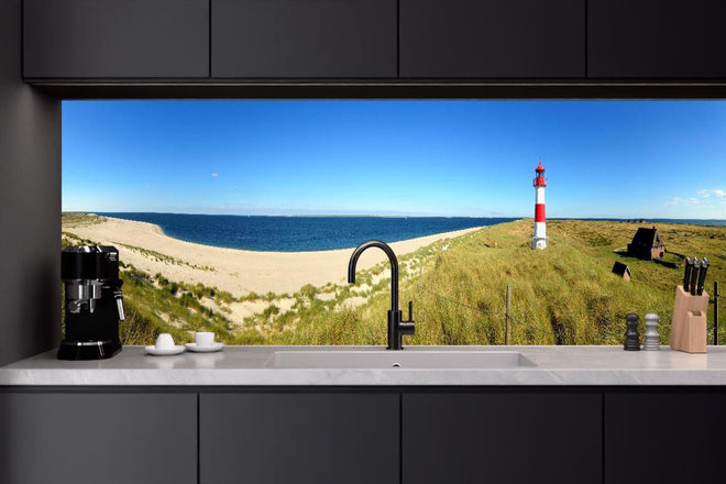 Küchenrückwand - Leuchtender Leuchtturm an idyllischem Sandstrand