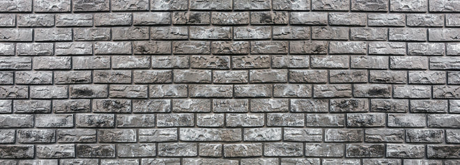 Küchenrückwand - Ziegelmauer aus dekorativem grauem Stein